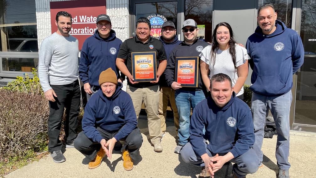 United team members with the 2022 and 2023 Best of LI award plaques.