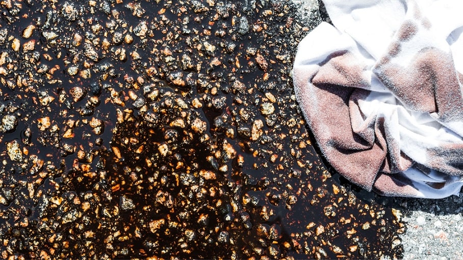 oil spill on cement with an oily rag
