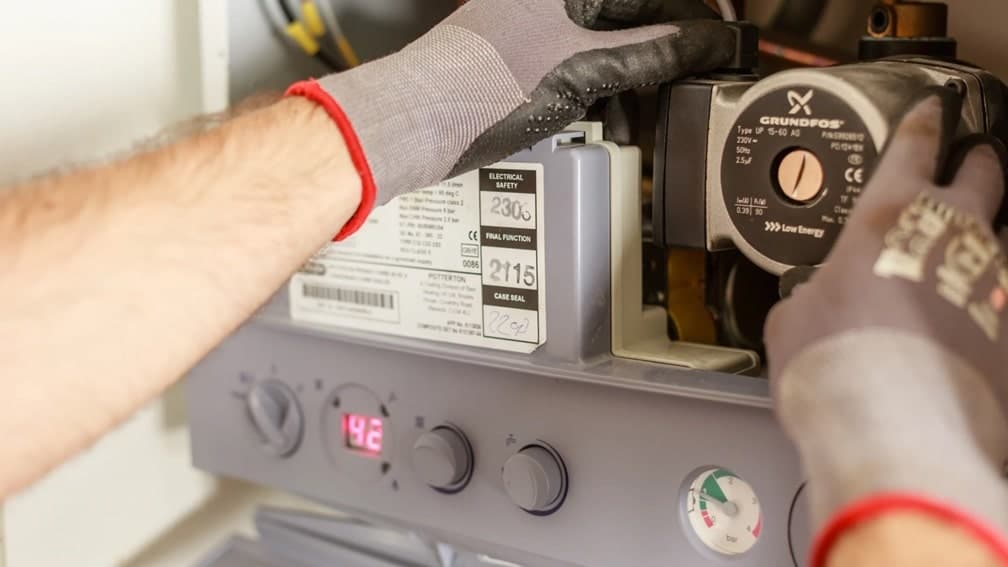 technician servicing a boiler